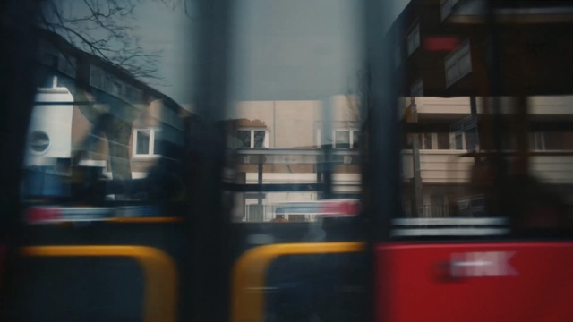 Video Reference: Reflection, Transport, Red, Mode of transport, Bus, Snapshot, Window, Line, Urban area, Sky