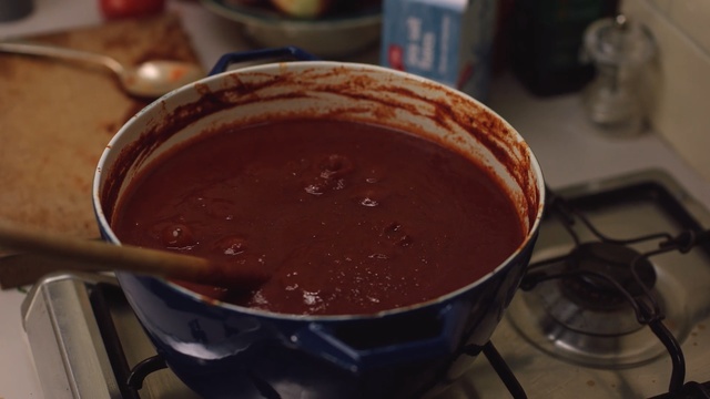 Video Reference: Dish, Food, Cuisine, Ingredient, Gravy, Brown sauce, Barbecue sauce, Mole sauce, Sauces, Champurrado, Cup, Indoor, Table, Sitting, Coffee, Soup, Plate, Bowl, Sandwich, Hot, Filled, Pot, Half, Pan, Wooden, Laptop, Computer, Stove, Banana, Desk, Keyboard, Cheese, White, Kitchen, Chocolate spread, Espagnole sauce, Dessert, Meal