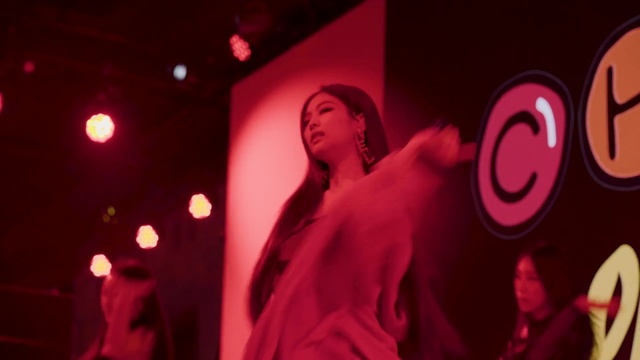 Video Reference: Red, Pink, Magenta, Performance, Maroon, Music, Event, Room, Fun, Performing arts, Person, Sign, Stop, Man, Front, Looking, Young, Standing, Sitting, Holding, Glasses, Girl, Close, Dark, Woman, Wearing, Black, Phone, White, Food, Street, Shirt, Human face, Dance, Light, Concert, Text