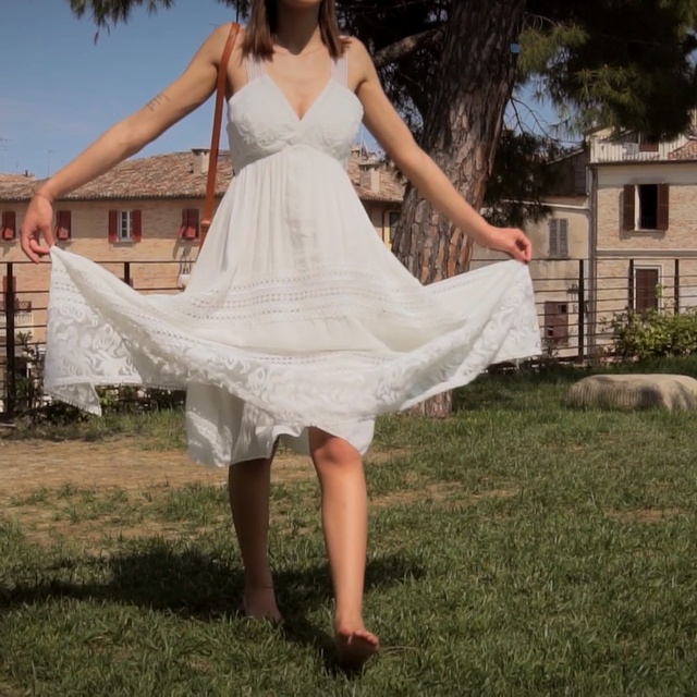 Video Reference: Wedding dress, Dress, Clothing, White, Photograph, Gown, Bridal clothing, Lady, Beauty, Bridal party dress, Outdoor, Grass, Person, Building, Woman, Young, Girl, Posing, Yard, Standing, Holding, Dressed, Large, Wedding, Man, Playing, Field, Elephant, Bride, Fashion