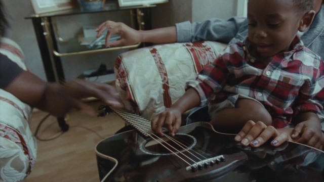 Video Reference: String instrument, String instrument, Guitar, Musical instrument, Music, Plucked string instruments, Sitting, Ukulele, Cavaquinho, String instrument accessory