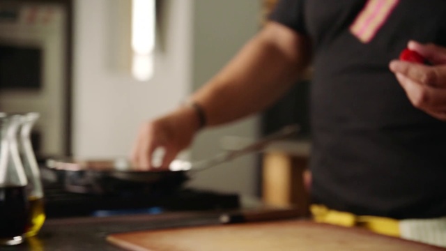 Video Reference: Food, Cooking, Cuisine, Hand, Room, Dish, Drink, Cook, Person, Indoor, Man, Table, Kitchen, Preparing, Woman, Standing, Using, Holding, Pizza, Shirt, Young, People, Computer, Music