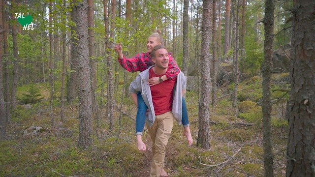 Video Reference: People in nature, Woodland, Forest, Natural environment, Tree, Wilderness, Nature reserve, Northern hardwood forest, Old-growth forest, Jungle, Person, Outdoor, Grass, Man, Wood, Holding, Standing, Frisbee, Wooded, Hand, Throwing, Walking, Building, Young, Green, Area, Woman, Wearing, Playing, Field, Hiking, Clothing, Human face, Smile, Plant, Arm