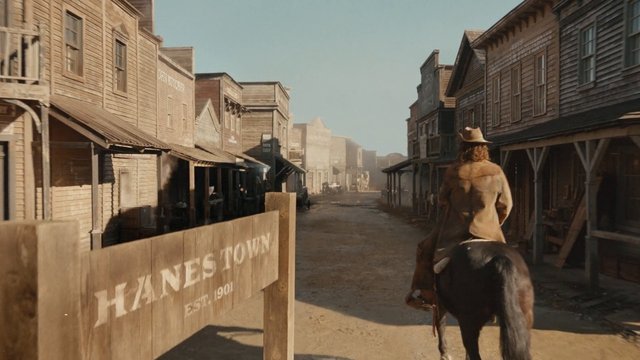 Video Reference: western, cowboy, horse, horseback, old town, main street, dusty, wooden buildings, frontier, historic, street scene, outdoor, travel, period setting