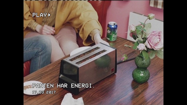 Video Reference: Room, Table, Wood, Photography, Flooring, Hardwood, Furniture, Interior design, Plant, Photo caption, Person, Indoor, Sitting, Man, Young, Boy, Living, Holding, Front, Small, Wooden, Using, Little, Laptop, Computer, Food, Playing, Standing, Text