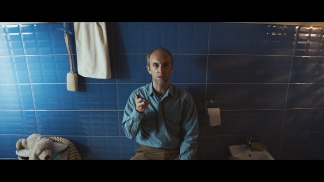 Video Reference: Screenshot, Human, Room, Digital compositing, Photography, Fictional character, Adventure game, Person, Indoor, Man, Woman, Looking, Blue, Front, Standing, Holding, Sink, Young, Table, Mirror, Teeth, Large, White, Brushing, Kitchen, Bathroom, Human face, Clothing, Male, Kitchen appliance
