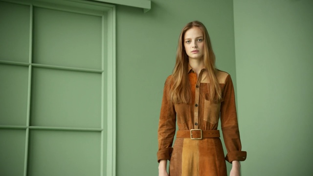 Video Reference: Clothing, Fashion, Outerwear, Standing, Jacket, Trench coat, Long hair, Coat, Leather, Blond, Person