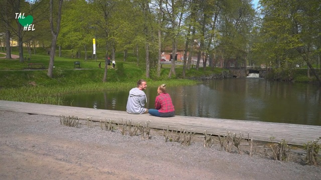 Video Reference: Water, Waterway, Bank, River, Canal, Tree, Watercourse, Leisure, Pond, Bayou, Person, Outdoor, Grass, Bench, Park, Sitting, Man, Building, Sidewalk, Side, Little, Standing, Wooden, Lake, Street, Red, Young, Body, People, White, Ground, Clothing, Plant