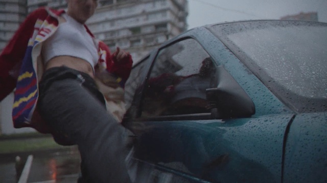 Video Reference: Vehicle door, Vehicle, Car, Automotive window part, Windshield, Glass, Auto part, City car, Window, Hood, Person, Man, Front, Woman, Holding, Standing, Young, Wearing, Little, Girl, Cake, Mirror, Table, Red, Hat, Street, Pizza, Plate, Riding, Phone, Land vehicle