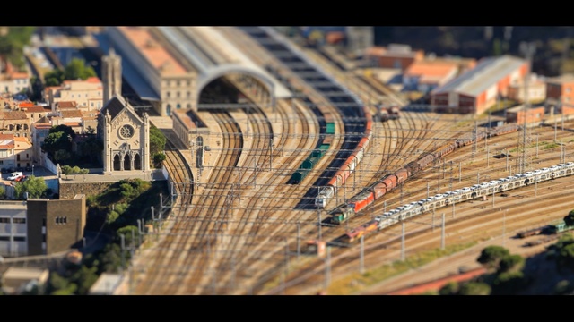 Video Reference: track, urban area, transport, city, metropolitan area, cityscape, landmark, metropolis, rail transport, residential area