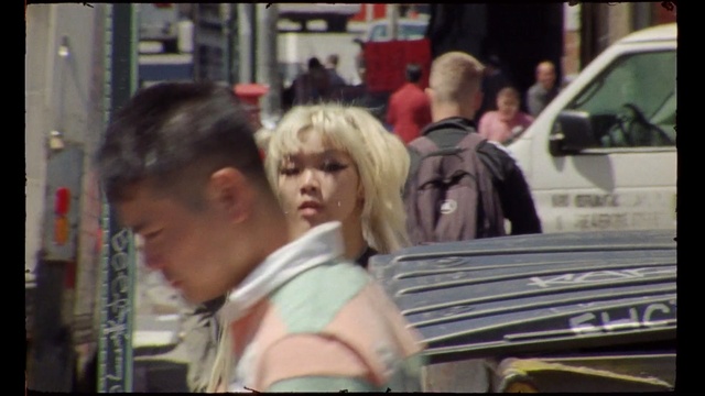 Video Reference: Motor vehicle, Snapshot, Mode of transport, Vehicle, Blond, Car, Automotive window part, Street, Photography, Person, Man, Sitting, Woman, Looking, Front, Laptop, People, Using, Bench, Computer, Table, Restaurant, Phone, Busy, Young, Holding, Group, Standing, Bus, Human face, Clothing, Text