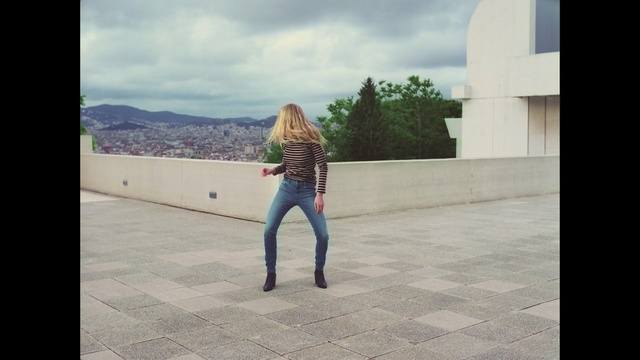 Video Reference: photograph, snapshot, vacation, sky, standing, jeans, road, girl, fun, trousers