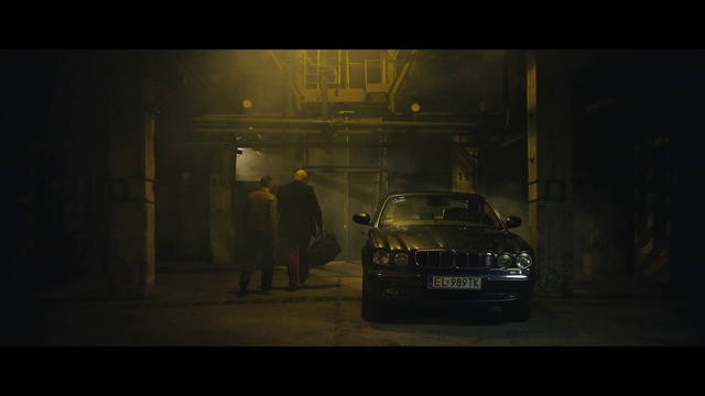 Video Reference: Car, Vehicle, Automotive lighting, Snapshot, Headlamp, Mode of transport, Darkness, Executive car, Midnight, Standing, Front, Refrigerator, Door, Display, Dark, Man, Bus, Street, Table, Woman, Room, Night, Store, Kitchen, White, Land vehicle, Text, Person, Wheel