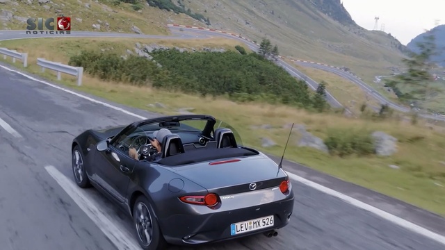 Video Reference: car, road, personal luxury car, vehicle, mode of transport, sports car, convertible, automotive design, luxury vehicle, performance car