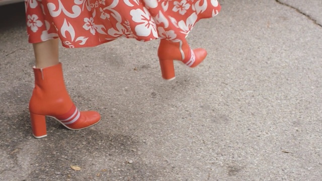 Video Reference: footwear, red, shoe, leg, flooring, floor, outdoor shoe, human leg, sandal, high heeled footwear, Person