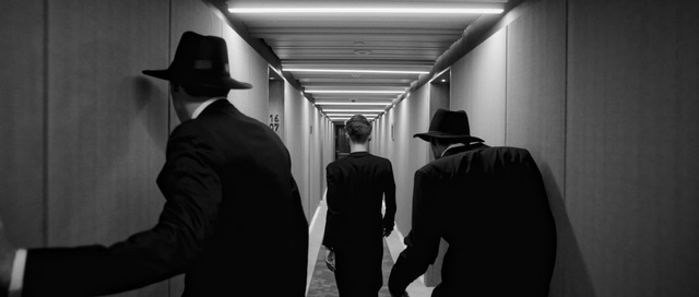 Video Reference: Black, Black-and-white, Standing, Monochrome, Film noir, Monochrome photography, Photography, Headgear, Suit, Movie