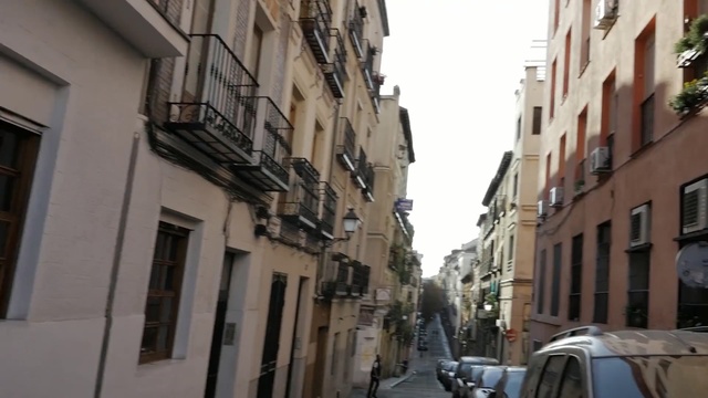 Video Reference: neighbourhood, town, street, property, alley, building, infrastructure, lane, road, city, Person