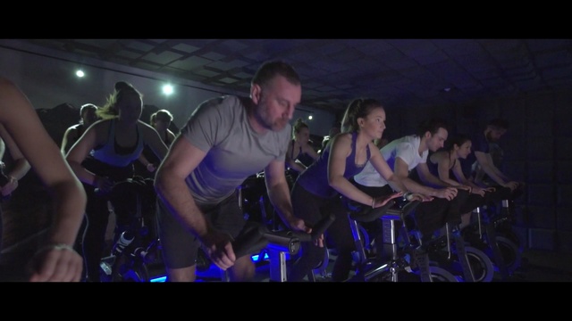 Video Reference: indoor cycling, rock concert, entertainment, performance, audience, darkness, crowd, event, stage, performance art