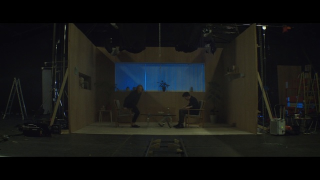 Video Reference: stage, darkness, film studio, entertainment, scene, sound stage, performance art, performance, midnight, screenshot, Person