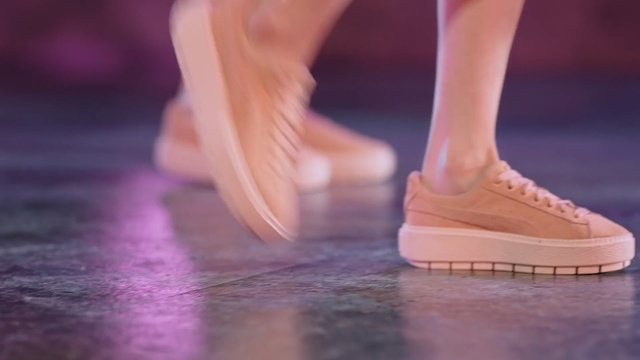 Video Reference: footwear, shoe, purple, leg, ballet flat, foot, outdoor shoe, floor, flooring, sneakers, Person