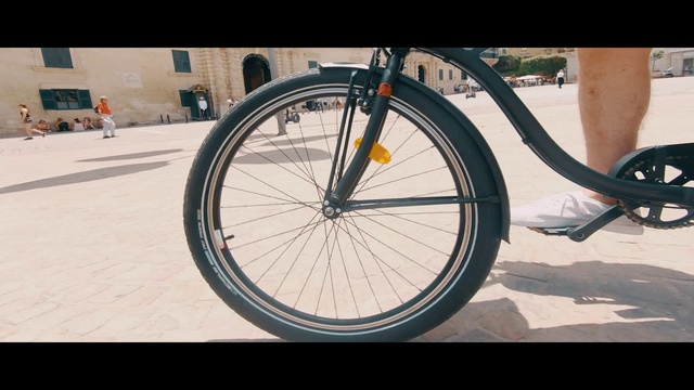 Video Reference: Bicycle wheel, Bicycle, Bicycle part, Bicycle tire, Spoke, Wheel, Vehicle, Bicycle frame, Tire, Bicycle fork, Person, Outdoor, Sitting, Parked, Standing, Man, Riding, Table, Bench, Laying, Beach, Large, Board, Park, Woman, Street, Dog, Red, White, Ground, Bike, Land vehicle, Sports equipment, Bicycle wheel rim, Bicycle stem, Transport, Crankset, Hub gear, Groupset, Bicycle chain, Bicycle seatpost, Bicycle saddle, Hybrid bicycle