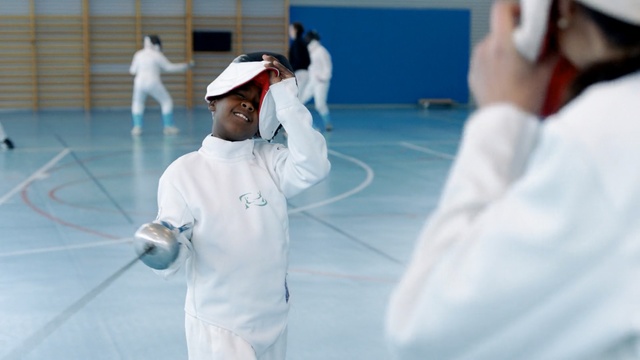 Video Reference: sport venue, competition, sports, personal protective equipment, leisure, recreation, competition event, joint, fencing, indoor games and sports, Person