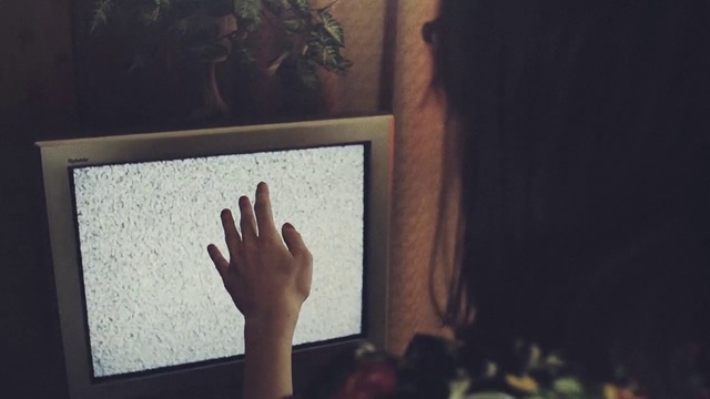 Video Reference: Hand, Room, Wall, Tree, Finger, Blackboard, Visual arts, Photography, Adaptation, Gesture, Person, Indoor, Front, Woman, Man, Looking, Standing, Mirror, Young, Holding, Sitting, Screen, Table, Monitor, Television, Girl, White, Wearing, Computer, Cat, Playing, Video, Living, Red, Bed, Clock, Painting, Text, Picture frame