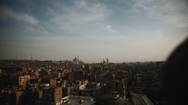 Video Reference: Sky, Urban area, Cloud, City, Metropolitan area, Daytime, Human settlement, Atmospheric phenomenon, Cityscape, Town, Person