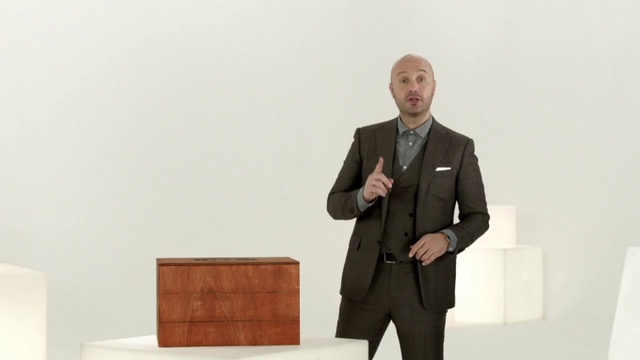 Video Reference: Suit, Standing, Public speaking, Formal wear, Businessperson, Tuxedo, Furniture, Outerwear, Orator, Business