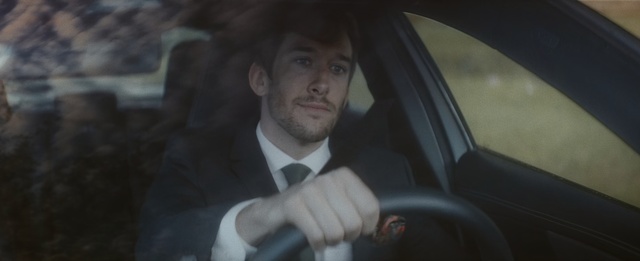 Video Reference: Driving, Vehicle door, Luxury vehicle, Family car, Suit, Vehicle, Car, Formal wear, Automotive window part, Fictional character