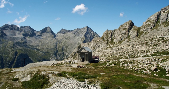 Video Reference: Mountainous landforms, Mountain, Mountain range, Highland, Alps, Natural landscape, Ridge, Wilderness, Massif, Fell, Person, Outdoor, Rock, Nature, Grass, Rocky, Hill, Sheep, Hillside, Covered, Side, Standing, Snow, Walking, Large, Field, Grazing, Red, Old, Man, Herd, Dirt, Sky, Cloud, Landscape, House, Stone