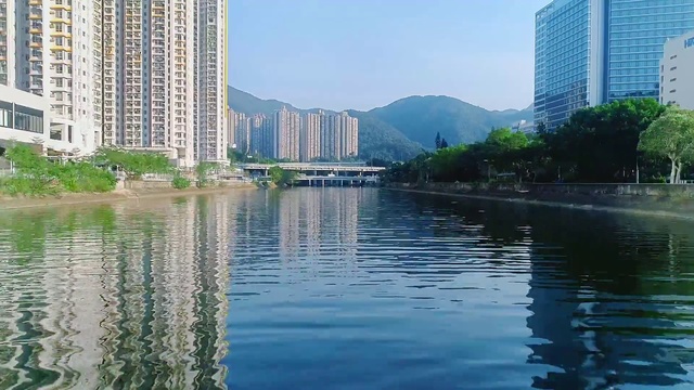 Video Reference: Metropolitan area, Reflection, City, Waterway, Water, Water resources, Daytime, Tower block, Metropolis, Human settlement
