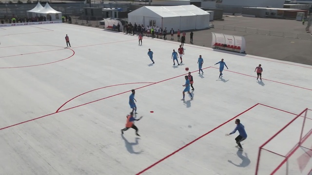 Video Reference: Hockey, Ice rink, Team sport, Bandy, Sports, Sport venue, Ball game, Stick and ball games, Skating, Sports equipment, Person, Skiing, Outdoor, Sport, Racquetball, Snow, Game, Racing, Man, People, Slope, Group, Bunch, Hill, Young, Air, White, Covered, Different, Flying, Many, Riding, Jumping, Large, Track, Ice skating, Athletic game, Footwear, Several