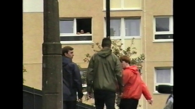 Video Reference: Photograph, People, Standing, Snapshot, Window, Facade, Neighbourhood, Mode of transport, Pedestrian, Urban area