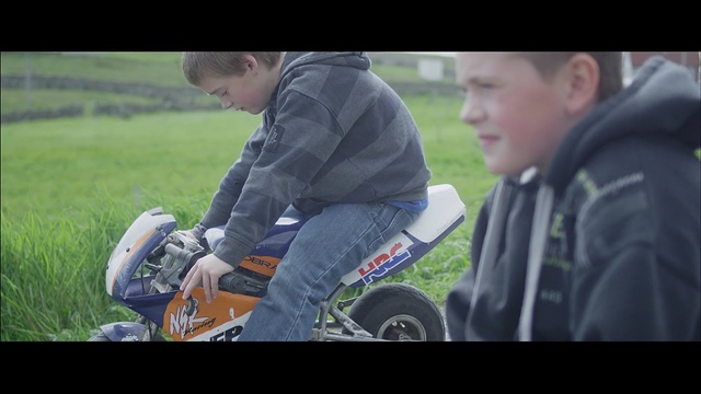 Video Reference: Grass, Vehicle, Lawn, Automotive tire, Soil, Sitting, Fun, Photography, Automotive wheel system, Plant, Person