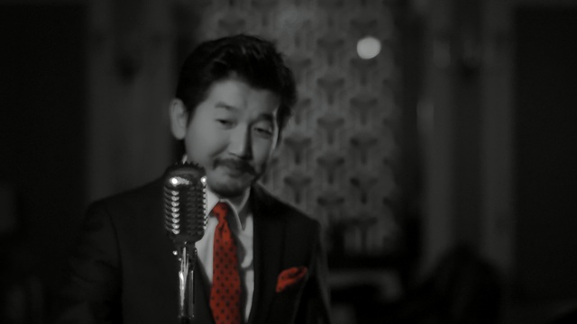 Video Reference: black, man, singing, gentleman, darkness, snapshot, performance, public speaking, pop music, human, Person