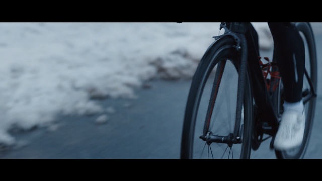 Video Reference: tire, automotive tire, wheel, bicycle, mode of transport, winter, snow, sky, snapshot, photography, Person