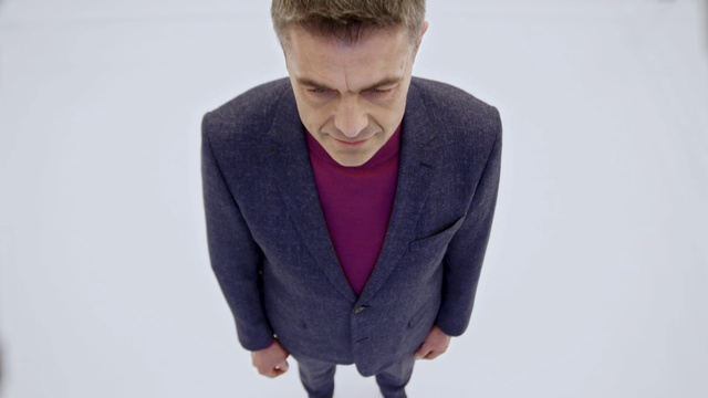 Video Reference: Outerwear, Blazer, Suit, Standing, Neck, Jacket, Human, Top, Formal wear, White-collar worker