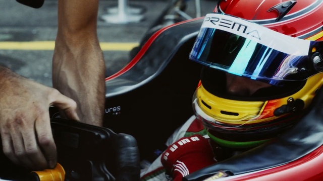 Video Reference: helmet, car, personal protective equipment, vehicle, race track, automotive design, racing, headgear, motorsport, protective gear in sports, Person