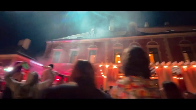 Video Reference: Building, Entertainment, Gas, Event, Magenta, Font, Fun, Crowd, House, Sky