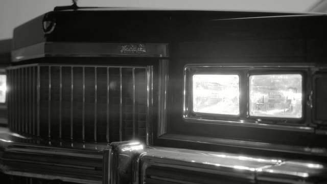 Video Reference: car, luxury vehicle, black and white, automotive design, vehicle, motor vehicle, automotive exterior, grille, monochrome photography, classic