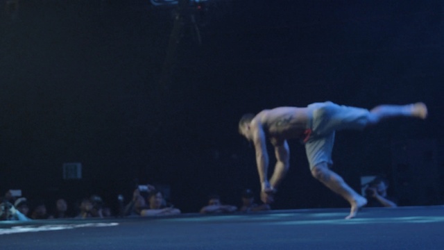 Video Reference: blue, performance, sport venue, performing arts, dancer, entertainment, competition, competition event, gymnastics, public event, Person