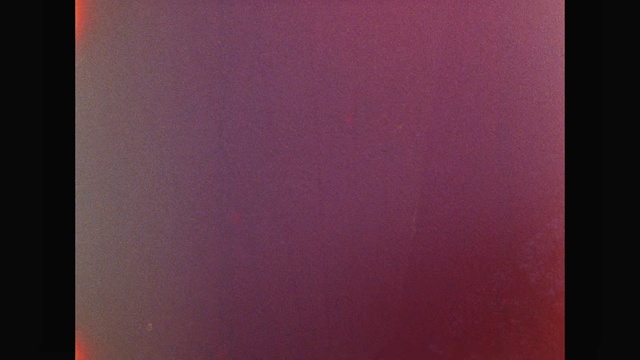 Video Reference: Red, Violet, Purple, Pink, Magenta, Maroon, Material property, Pattern, Indoor, Sitting, White, Door, Monitor, Computer, Black, Laptop, Light, Table, Food, Man, Screen, Sign, Mirror, Room, Refrigerator, Blue, Standing, Sink, Abstract, Text, Brown, Fog