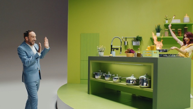 Video Reference: Green, Room, Furniture, Interior design, Shelf, Plant, Indoor, Woman, Standing, Holding, Playing, Front, Man, Table, Lady, Young, Girl, Bedroom, Mirror, Yellow, Game, Video, Wii, Remote, Bed, Sink, White, Wall, Bathroom, Design, Plumbing fixture, Vase, Tap