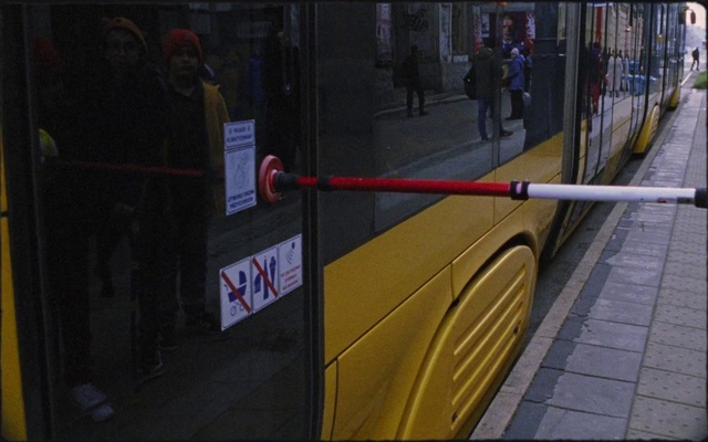 Video Reference: Transport, Mode of transport, Yellow, Snapshot, Metropolitan area, Public transport, Street, Sidewalk, Infrastructure, Pedestrian