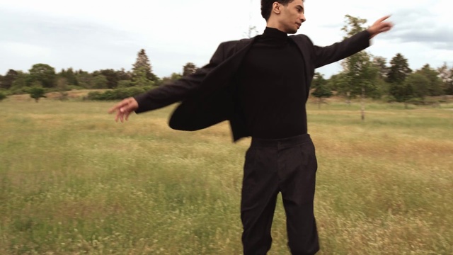 Video Reference: Arm, Standing, Grassland, Gesture, Grass, Outerwear, Baguazhang, Photography, Tai chi chuan, Suit