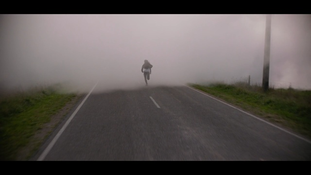 Video Reference: running, run, road, lane, fog, mode of transport, infrastructure, sky, mist, atmosphere, morning, road surface, Person