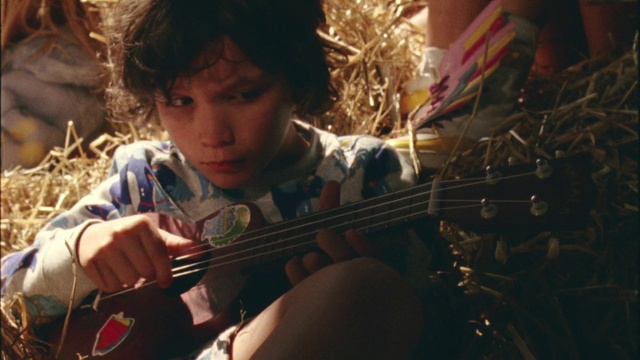 Video Reference: String instrument, Musical instrument, Violin, Child, Music, Musician, Guitar, Plucked string instruments, Play, Person, Indoor, Sitting, Young, Boy, Little, Looking, Holding, Man, Instrument, Wearing, Girl, Using, Small, Food, Table, Shirt, Eating, Woman, Standing, Playing, Plate, Phone, Cello, Human face, Bowed instrument, Bass