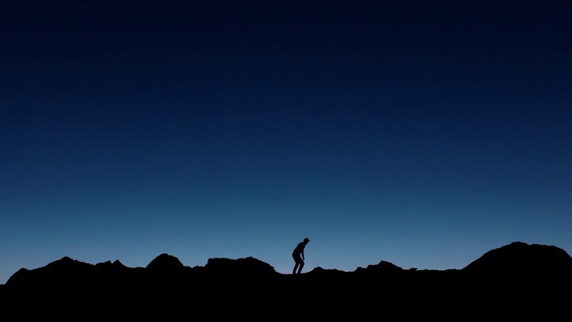 Video Reference: Sky, Blue, Black, Silhouette, Horizon, Cloud, Dusk, Landscape, Atmosphere, Tree, Outdoor, Mountain, Hill, Background, Standing, Dark, Sunset, Flying, Large, Kite, Field, Water, Grazing, Green, Sun, Grassy, Air, Walking, Man, Group, Tall, Hiking, Nature, Distance, Day