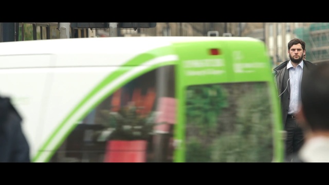 Video Reference: green, transport, vehicle, mode of transport, public transport, car, grass, advertising, tree, rolling stock, Person